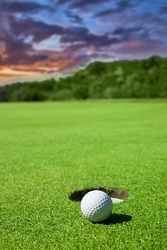 Close up of a golf ball close to the hole