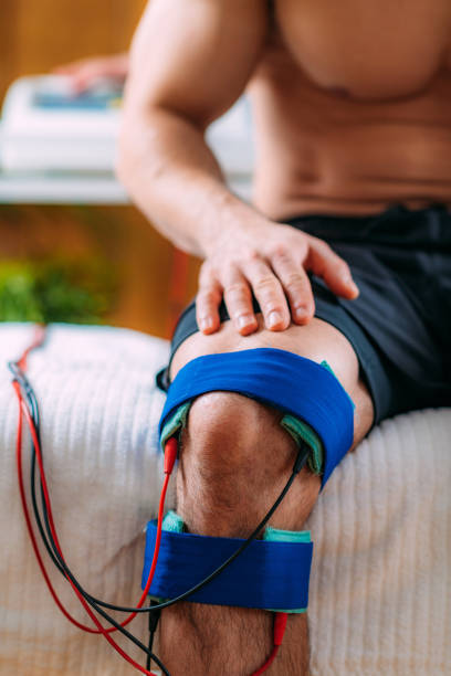 istock Knee Interferential Therapy with Electrode Brace Pads. Electrotherapy 1319498315