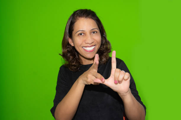 Young Woman Pointing and Laughing Outdoors.