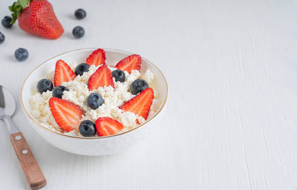 istock Quark or cotage cheese made from fermented milk decorated with summer season berries served in bowl on white wooden background for breakfast 1319500165