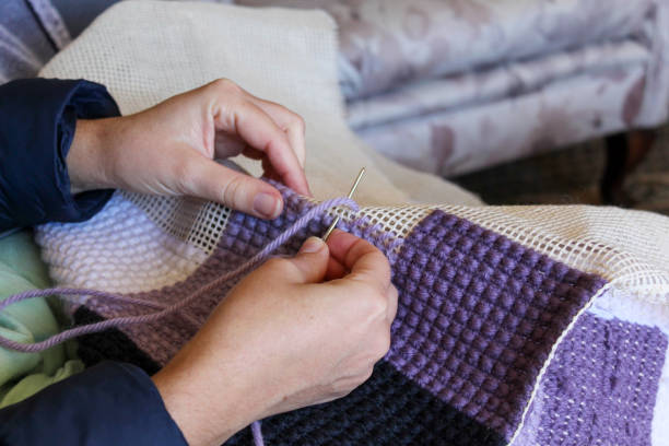 istock carpet being handmade. colorful needle and stitch closeup 1319502762