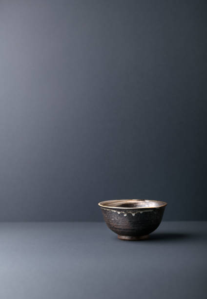 Traditional ceramic bowl on gray background. Soft focus. Copy space.