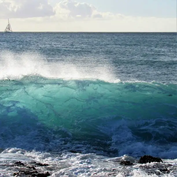 Waves forming, peaking and rolling onto Ko'Olina reef coastline along Oahu Hawaiis West shore.