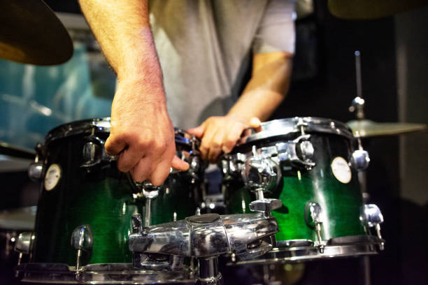 istock Man adjusts a percussion instrument, musical concept with the working drum 1319508968