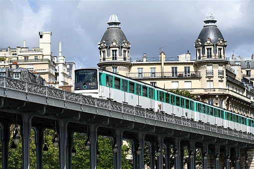 Paris, France-05 21 2021:An elevated subway train passing on a railway bridge above the Seine river in Paris, France.