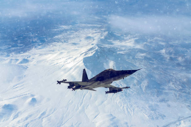 istock Jet fighter flying over the clouds in a snowy day. 1319511310