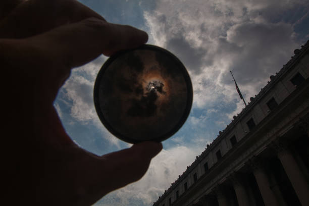 Solar eclipse in New York City: Sun stellar corona inside the neutral density filter ring against the USPS building near 34th Street and 8th Avenue, Penn Station area
