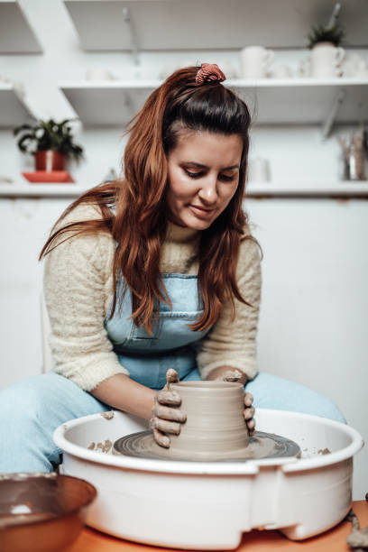 istock Female potter hands close up 1319515420