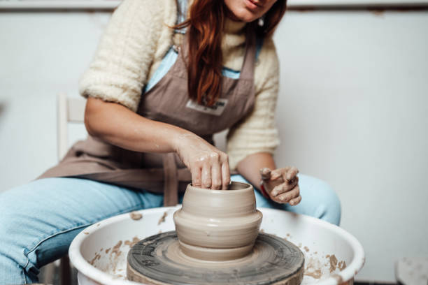 istock Female potter hands close up 1319515504