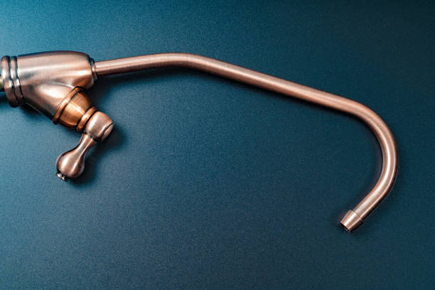 istock Brass tap to filter drinking water on a black background. 1319519258