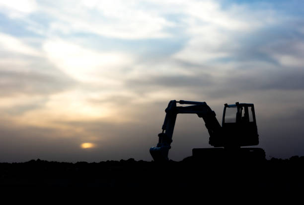 istock Silhouette of Bulldozer at a Construction Site 1319522501