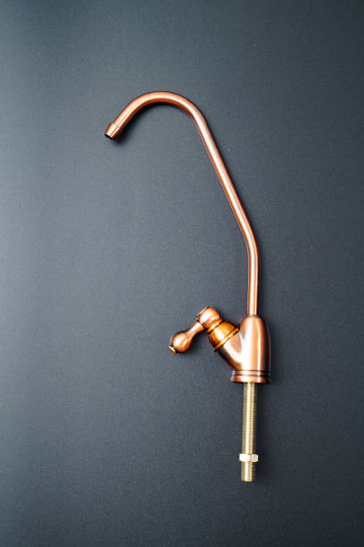istock Brass tap to filter drinking water on a black background. 1319523294