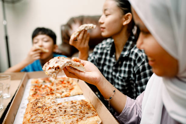 istock dinner party at home with pizza 1319535762