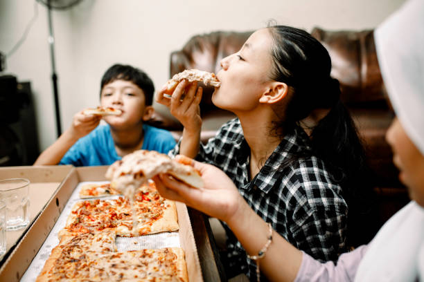 istock dinner party at home with pizza 1319535776