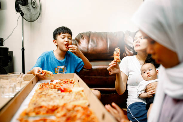 istock family party at home with pizza 1319535832