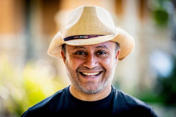 istock Smiling mature hispanic man looking at the camera wearing a cowboy hat 1319540335