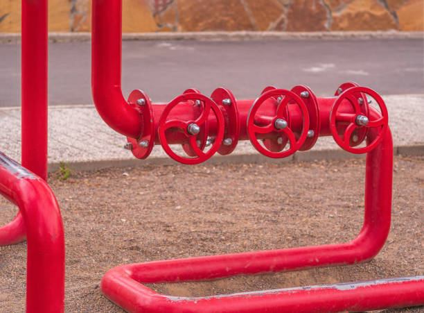 istock Fire safety system. Three consistent valves with red pipes for water. Outdoors. Close-up. 1319543277