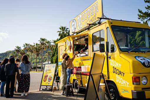 Young boy buying lunch from a food truck in Japan