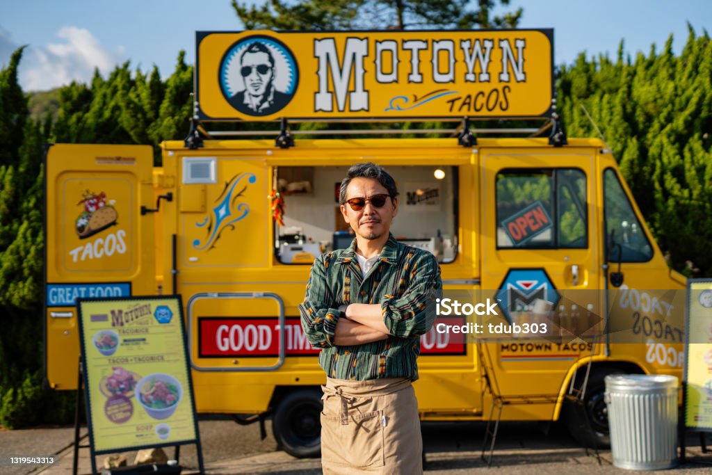 Portrait of an entrepreneur with his food truck Portrait of a mature male entrepreneur with his food truck in Japan Food Truck Stock Photo