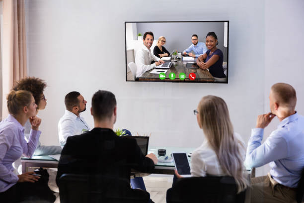 istock Businesspeople Video Conferencing In Boardroom 1319547269