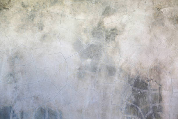 istock Abstract concrete wall with cracked and scratched surface texture background. 1319547937