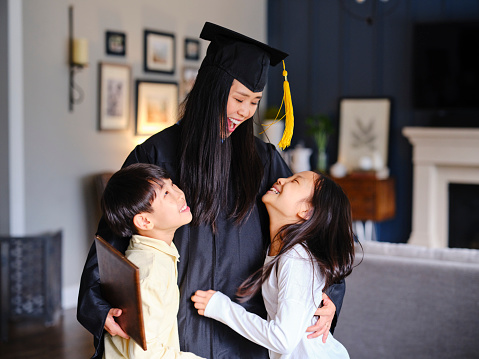 An adult woman celebrating her graduation from college.