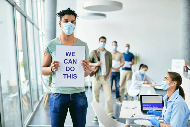 istock Young black man showing placard with 