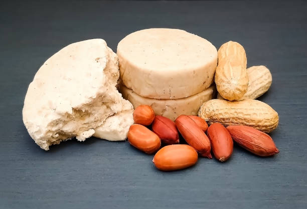 Mazapán next to peanuts on gray wooden background. Traditional sweet Mazapán next to peanuts on gray wooden background. marzipan stock pictures, royalty-free photos & images