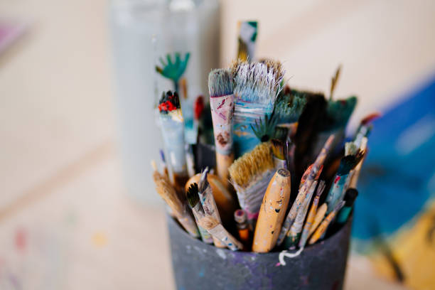 istock a cup with dirty brushes after drawing. accessories and tools for the artist. 1319552532