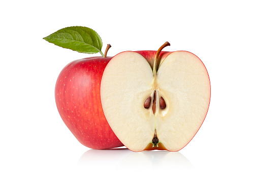 Red apple cut in half and apple with leaf isolated on a white background.
