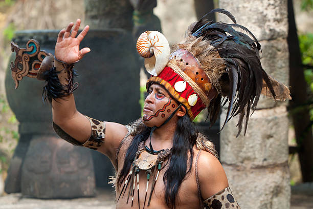 Mayan shaman Xcaret,Mexico - July 19, 2011 Unkown man in Mayan shaman uniform beginning traditional Mayan performance in the jungle of Xcaret park. This is the most famous Mayan performance in Mexico. warrior person stock pictures, royalty-free photos & images