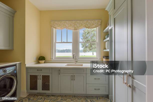 Yellow Painted Walls In New Laundry Room Stock Photo - Download Image Now - Utility Room, Laundry Basket, Cabinet