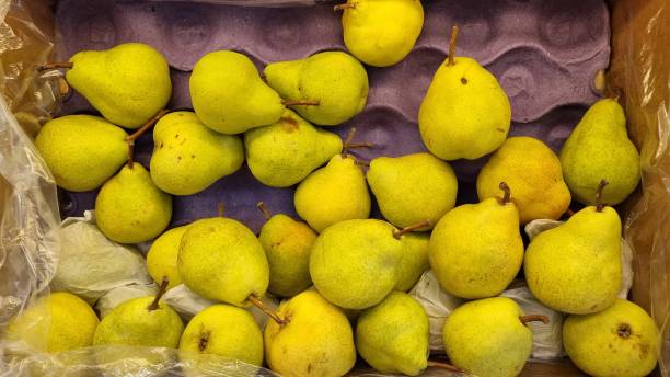 istock pears in a box. selling fruit and vegetables in the supermarket. 1319557579