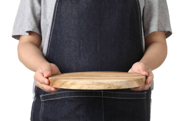 istock Chef holding wooden cutting board isolated on white background 1319558544