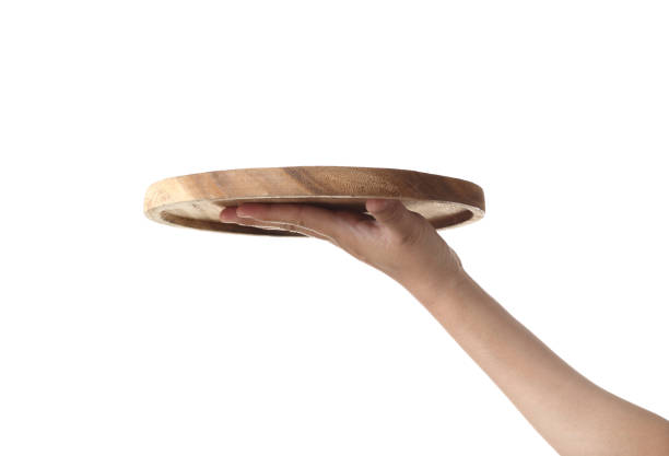 istock Chef holding wooden cutting board isolated on white background 1319558571