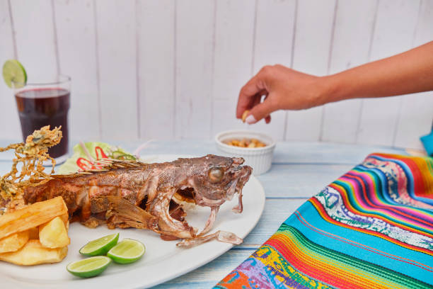 istock Peruvian food fried fish delicious dish: Cabrilla frita, fried fish . Selective Focus 1319560521