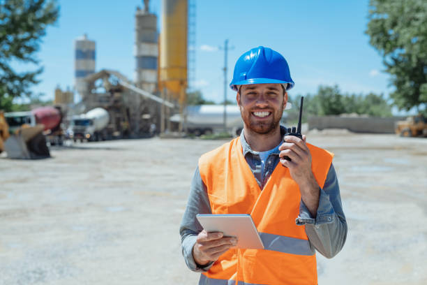 istock Engineer with hardhat working in logistics, looking at camera and smiling 1319560580