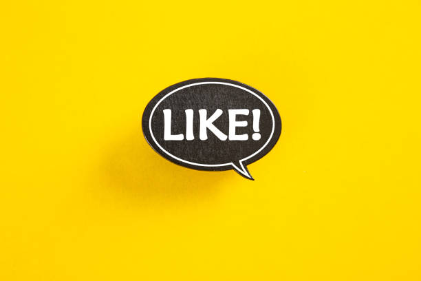 istock Like speech bubble isolated on yellow paper background with drop shadow. 1319560584