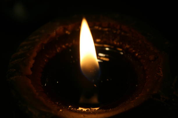 istock A big candle burning in dark close-up view of it 1319563192
