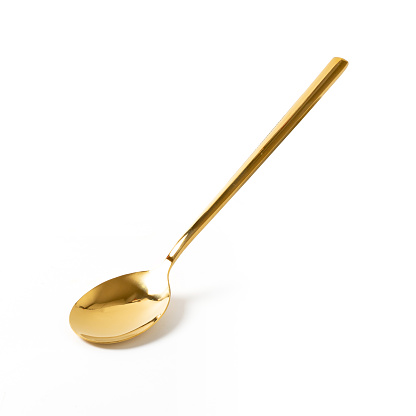 gold spoons on white background