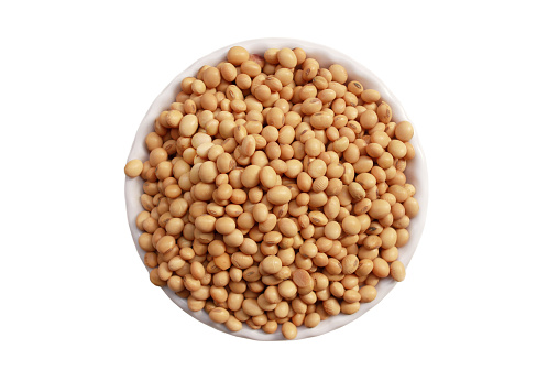 Soybean in bowl on white background. The soybean or soya bean (Glycine max) is a species of legume native to East Asia, widely grown for its edible bean, which has numerous uses. Traditional unfermented food uses of soybeans include soy milk, from which tofu and tofu skin are made.