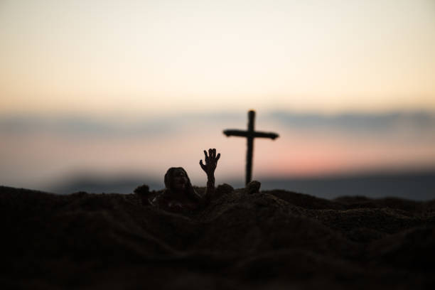 istock Silhouette some zombies on the cemetery walking around at sunset. Selective focus 1319565708