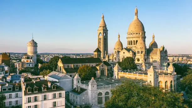 Aerial view of Montmartre hill with Basilique du Sacre-Coeur in Paris at sunset