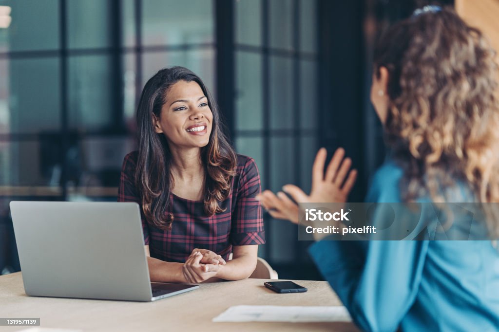 Colleagues discussing business Businesswomen talking in the office Job Interview Stock Photo