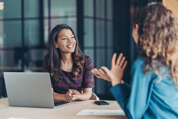 Colleagues discussing business Businesswomen talking in the office Talk stock pictures, royalty-free photos & images