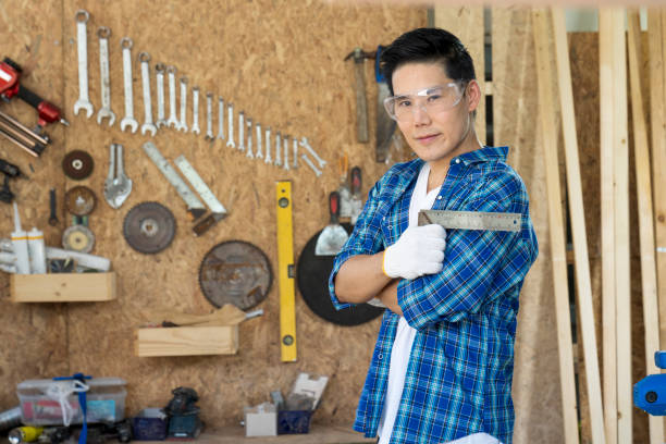 istock Carpenters working in teamwork. Wood processing at carpentry shop. 1319571981