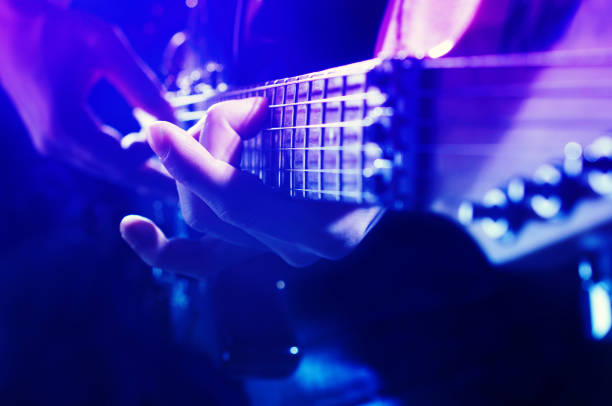 istock Young man plays electric guitar 1319575750