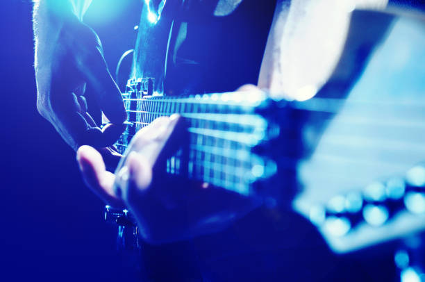 istock Young man plays electric guitar 1319575813