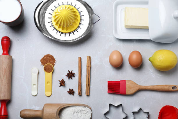 istock Cooking utensils and ingredients on light marble table, flat lay 1319576910