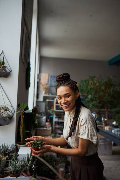 istock Florist with a mini succulent in her hands looking ahead 1319577347